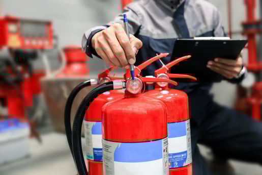 Commercial fire extinguishers being inspected by a professional