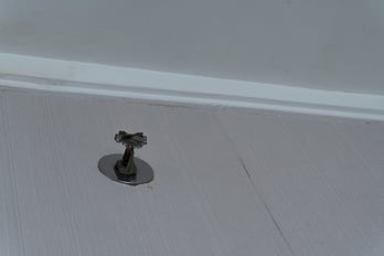 A commercial sprinkler head under code enforcement.