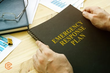 man-open-disaster-and-emergency-response-plan-for-reading-picture-id1223446457